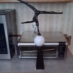 Artistic Black Metal Sculpture with White Sphere